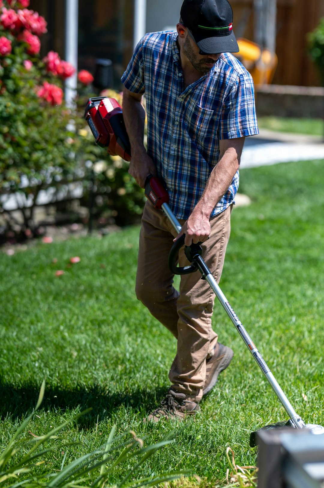 gallery-05 Man edging and weed eating a lawn with a battery powered edger