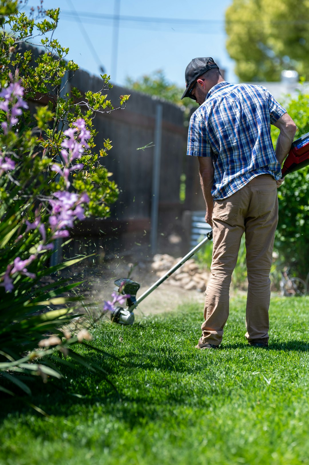 gallery-02 Man edging a lawn with a weed eater